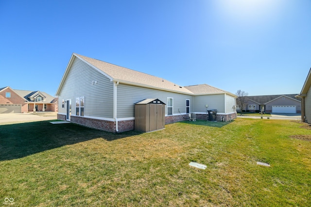 rear view of house featuring a yard and cooling unit