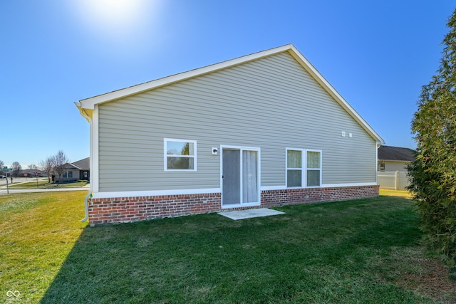 rear view of property with a lawn