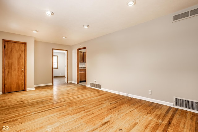 empty room with light hardwood / wood-style flooring