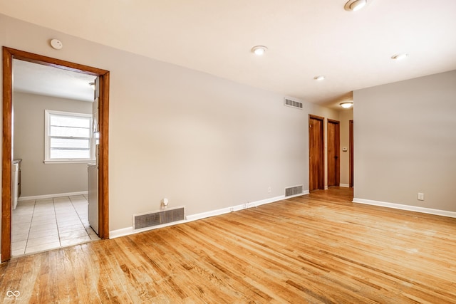 empty room with light hardwood / wood-style flooring