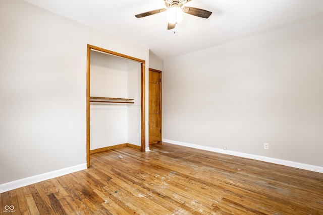 unfurnished bedroom featuring hardwood / wood-style flooring, a closet, and ceiling fan