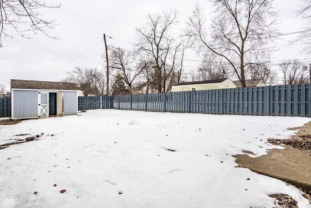 yard covered in snow with a shed