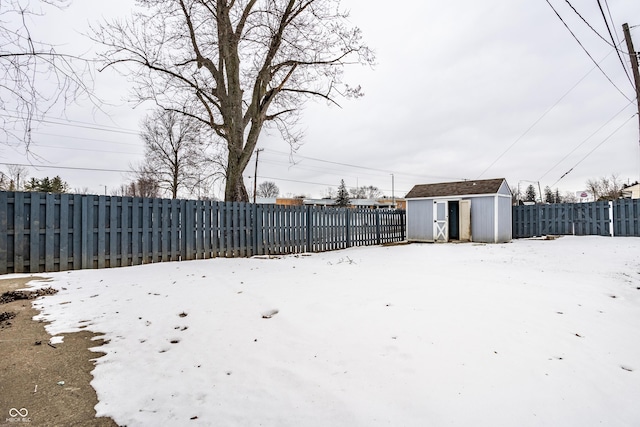 snowy yard with a shed