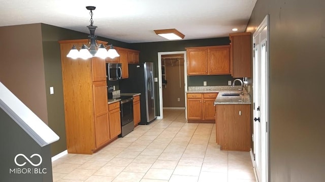 kitchen with hanging light fixtures, sink, light stone countertops, an inviting chandelier, and stainless steel appliances