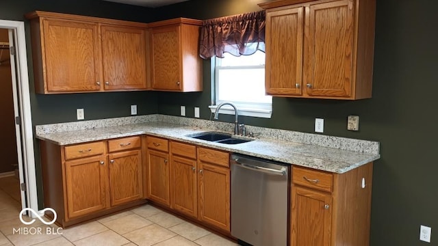 kitchen with sink, stainless steel dishwasher, light tile patterned floors, and light stone counters