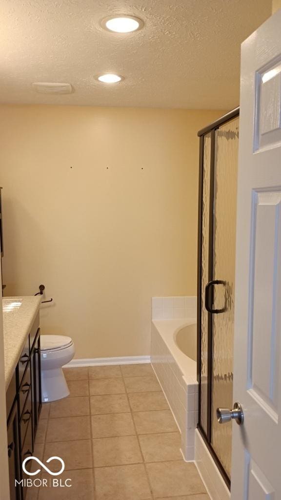 full bathroom with tile patterned floors, a textured ceiling, toilet, vanity, and shower with separate bathtub