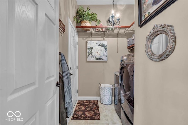 spacious closet with light tile patterned floors and washer and dryer