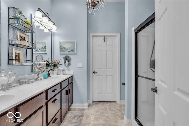 bathroom with a shower with shower door, tile patterned floors, and vanity