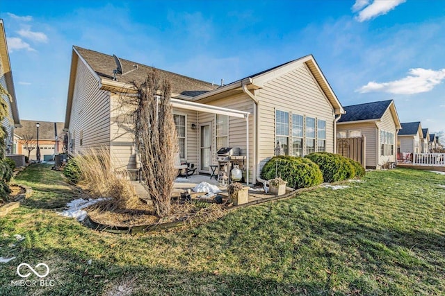 rear view of house featuring a patio, central AC unit, and a yard