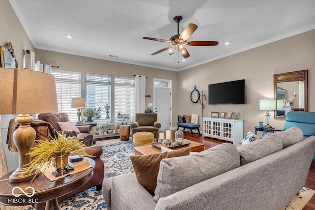 living room with wood-type flooring, ceiling fan, and crown molding