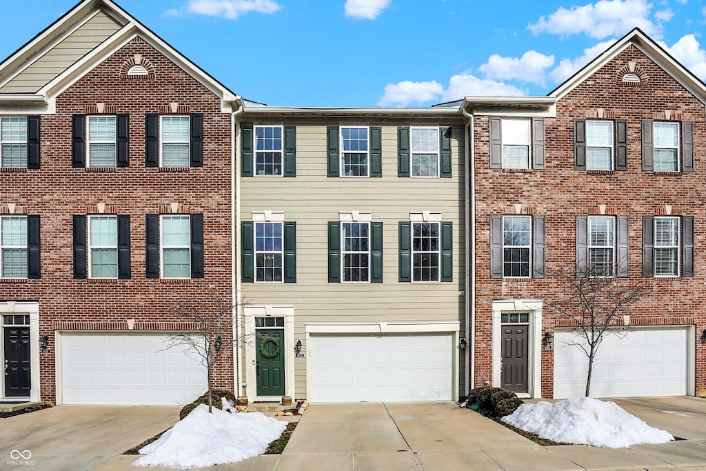 townhome / multi-family property featuring a garage