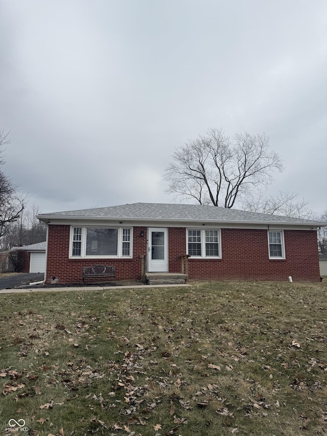 single story home featuring a garage and a front yard