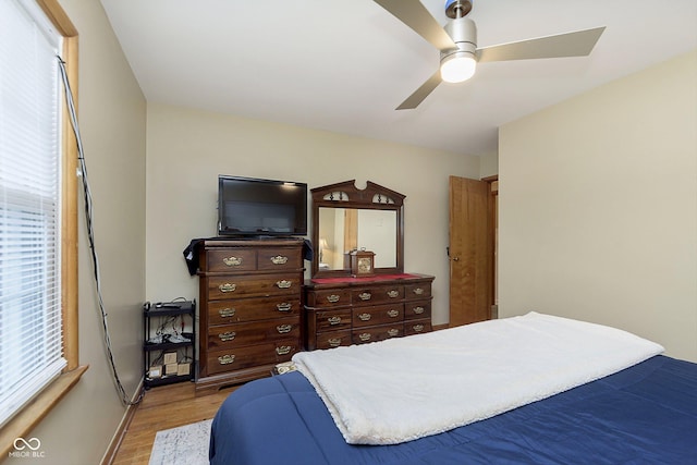 bedroom with light hardwood / wood-style flooring and ceiling fan