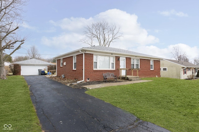 ranch-style home featuring a garage, an outbuilding, and a front yard