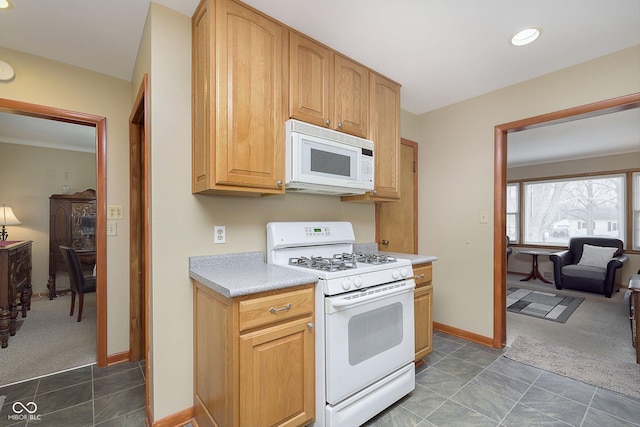 kitchen featuring dark carpet and white appliances