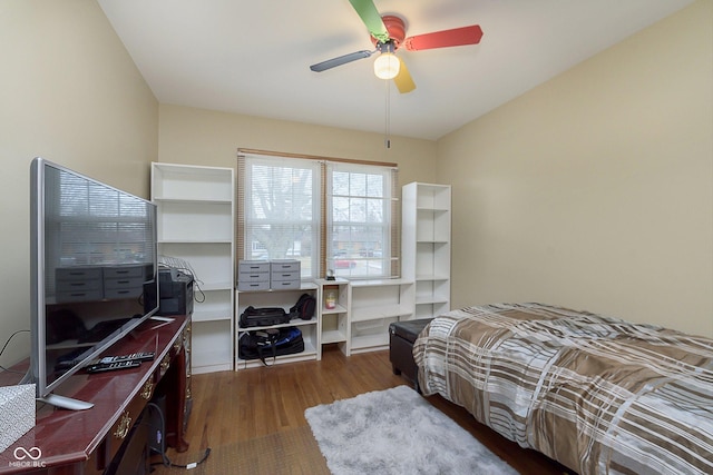 bedroom with dark hardwood / wood-style floors and ceiling fan