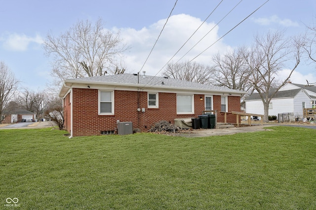 rear view of house featuring a lawn