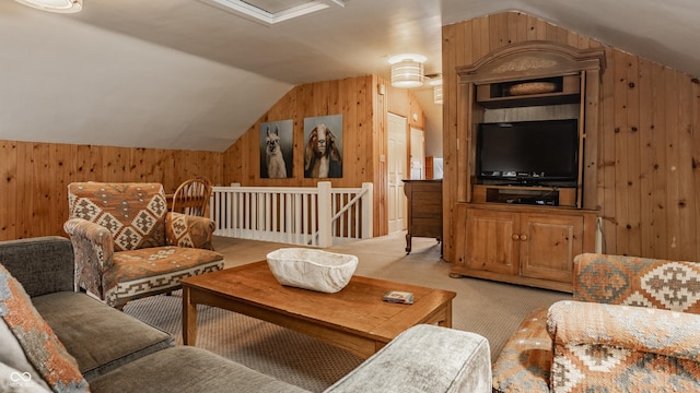 carpeted living room with vaulted ceiling and wooden walls