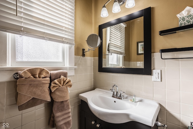 bathroom featuring vanity and tile walls