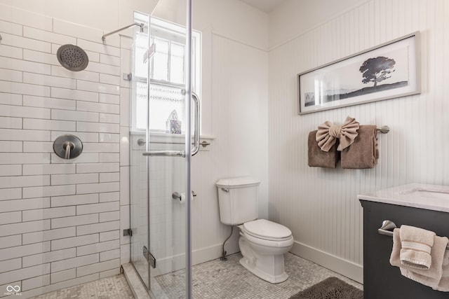 bathroom featuring tile patterned floors, toilet, walk in shower, and vanity