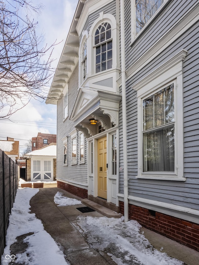 view of snow covered property entrance