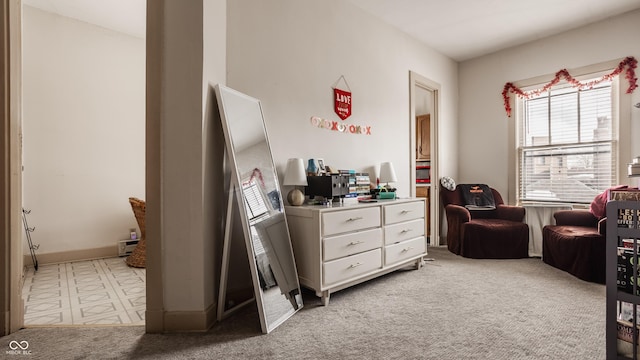 living area featuring light carpet