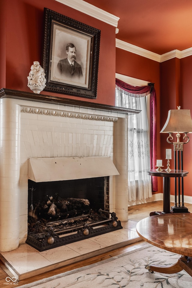 details with a brick fireplace, ornamental molding, and hardwood / wood-style floors