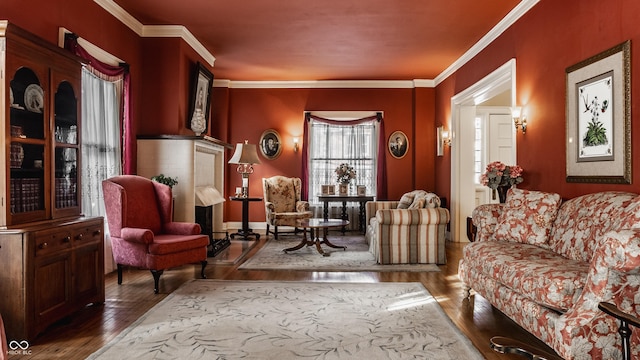 sitting room with hardwood / wood-style flooring and ornamental molding