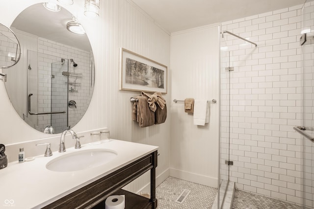 bathroom featuring vanity, tile patterned flooring, an enclosed shower, and ornamental molding