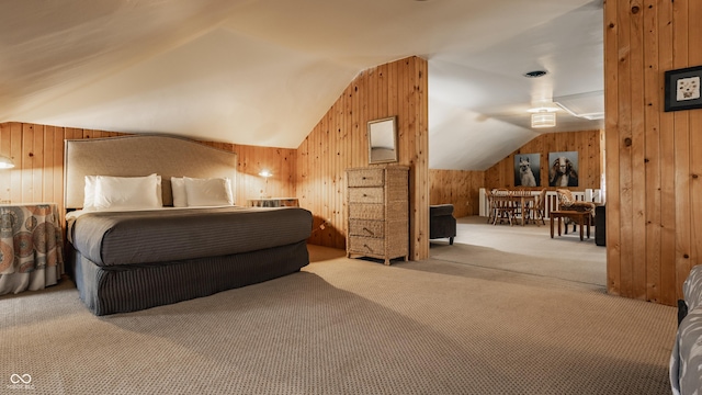 bedroom featuring light carpet, wood walls, and vaulted ceiling