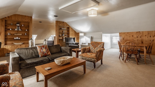 living room with built in shelves, light colored carpet, wooden walls, and lofted ceiling