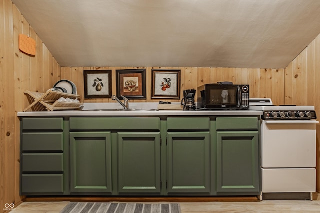 kitchen with vaulted ceiling, wood walls, green cabinetry, and white range with electric cooktop