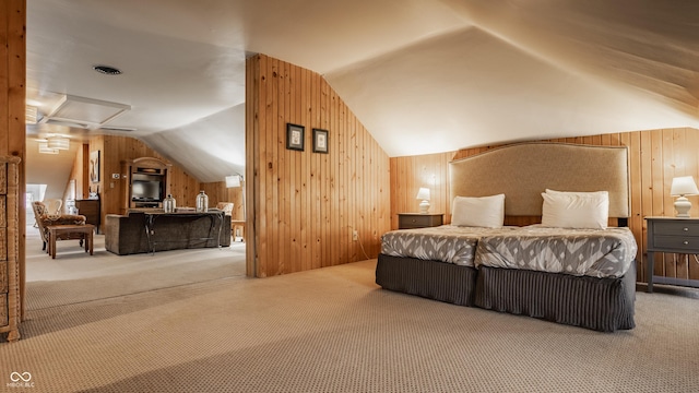 bedroom featuring vaulted ceiling, carpet flooring, and wooden walls