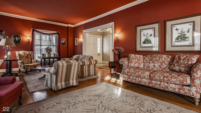 living room with crown molding, baseboards, and wood-type flooring