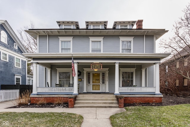 traditional style home with fence and covered porch