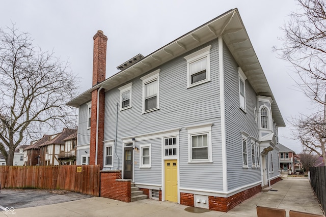 exterior space with a chimney and fence