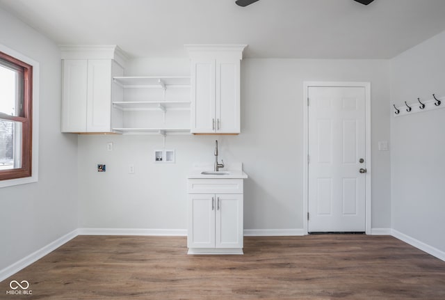 clothes washing area featuring sink, washer hookup, and dark hardwood / wood-style flooring