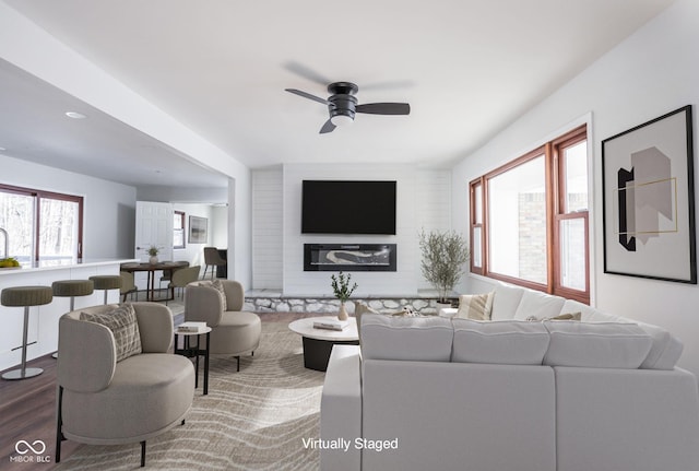 living room with wood-type flooring and ceiling fan