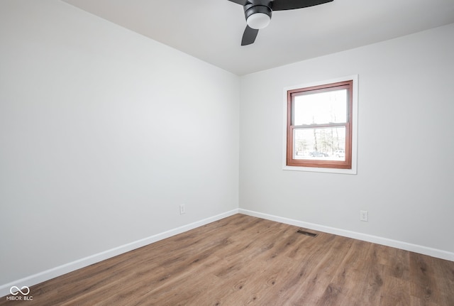 empty room featuring wood-type flooring and ceiling fan