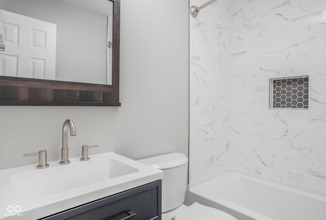 full bathroom featuring vanity, tiled shower / bath combo, and toilet