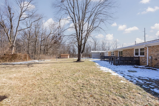 yard layered in snow featuring a wooden deck