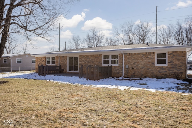 snow covered property with a lawn