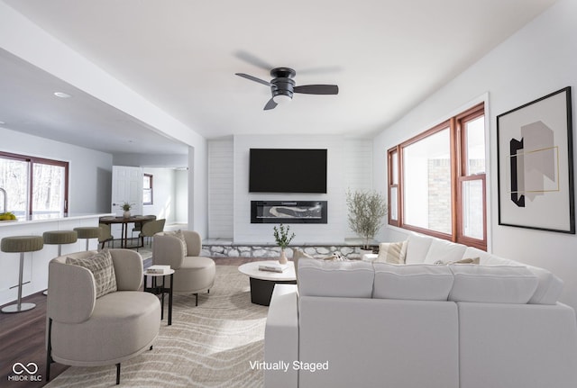 living room with hardwood / wood-style floors and ceiling fan