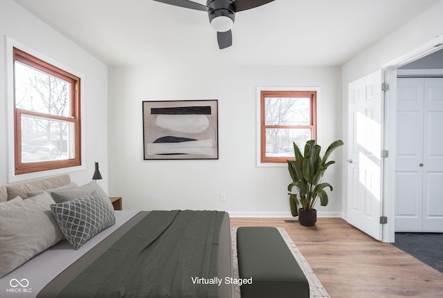 bedroom featuring multiple windows, ceiling fan, and light hardwood / wood-style floors