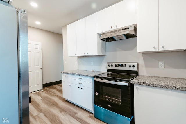 kitchen with light hardwood / wood-style flooring, stainless steel fridge, electric range, light stone counters, and white cabinets