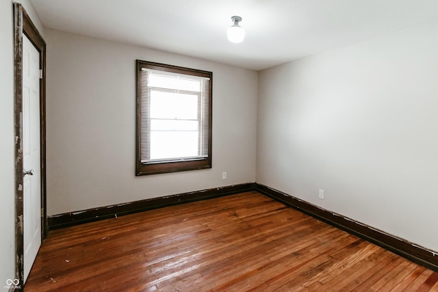 empty room featuring dark hardwood / wood-style flooring