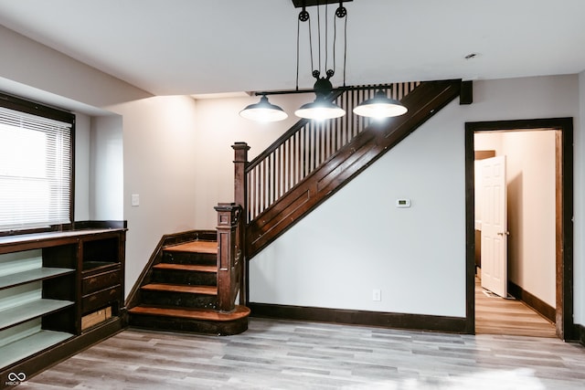 staircase with hardwood / wood-style flooring