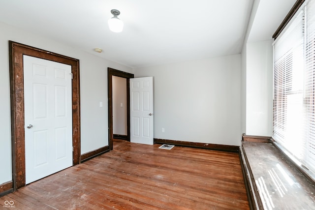 unfurnished bedroom with wood-type flooring