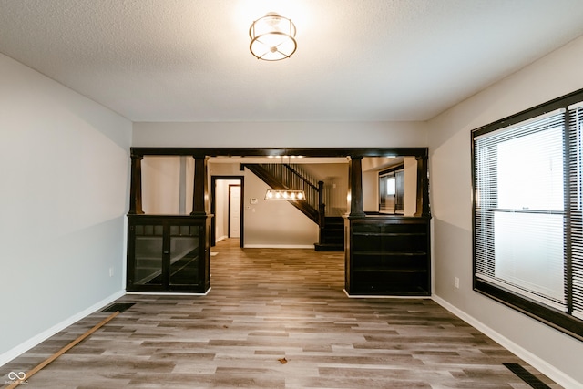 empty room featuring hardwood / wood-style flooring and a textured ceiling