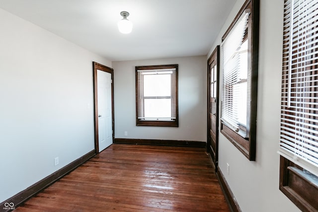 unfurnished bedroom with dark wood-type flooring